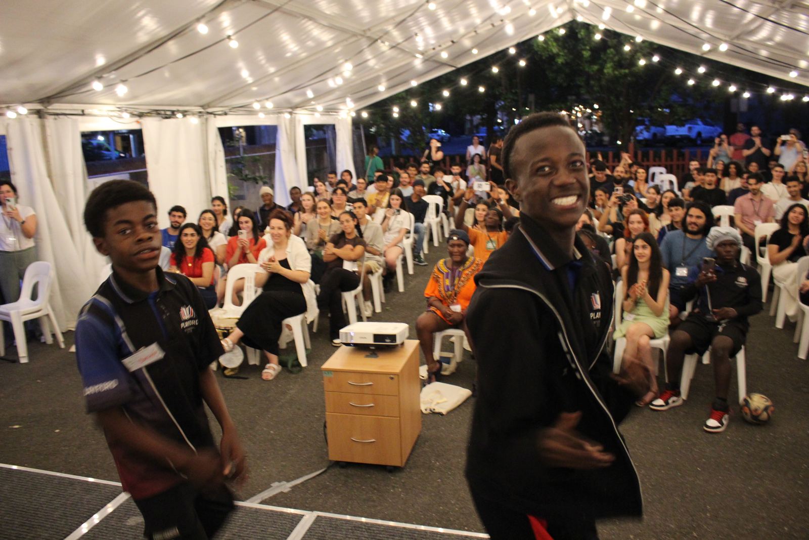 Two young dancers grinning mid-performance