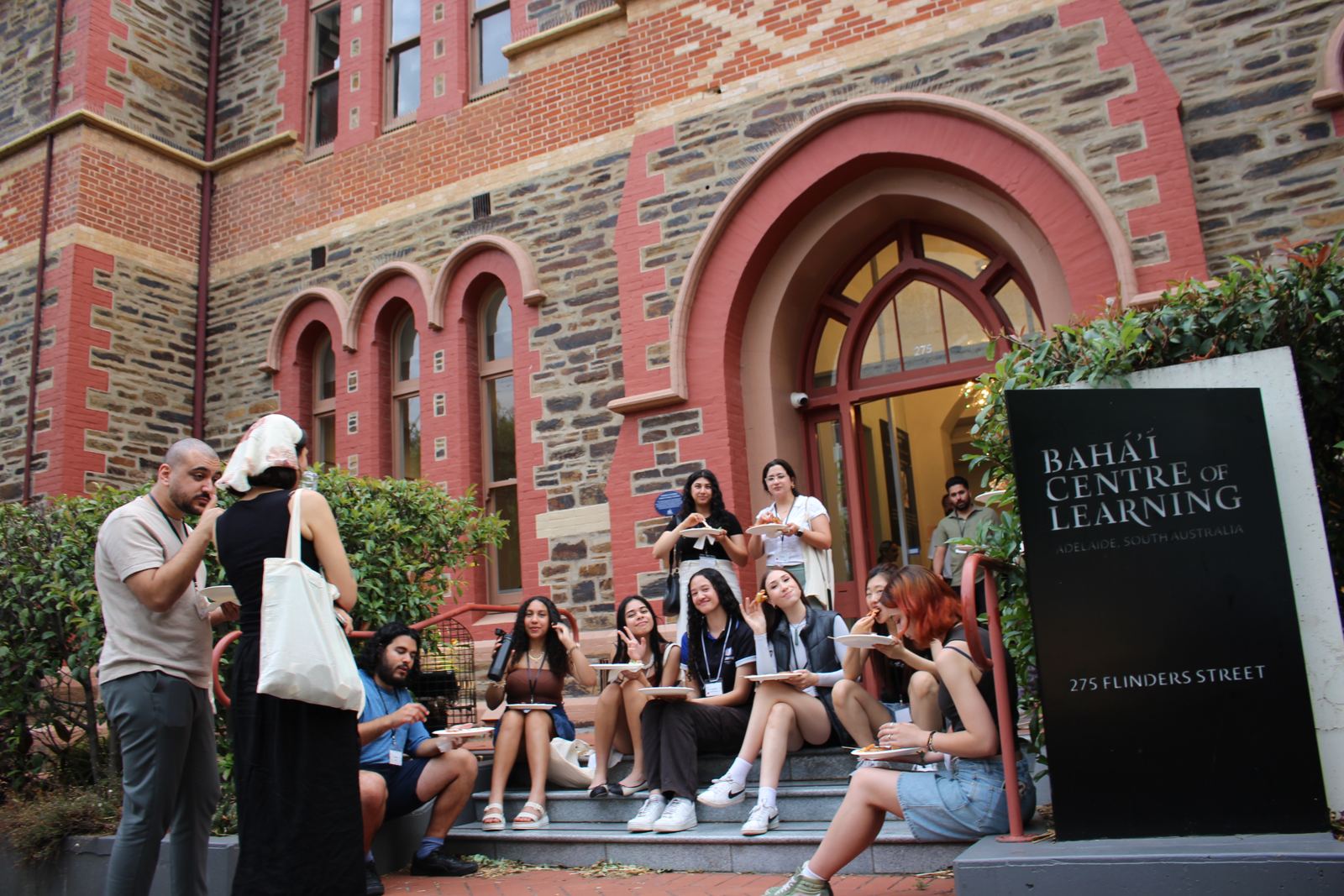 Youth gathered on the steps of the Bahá'í Centre of Learning on Flinders Street